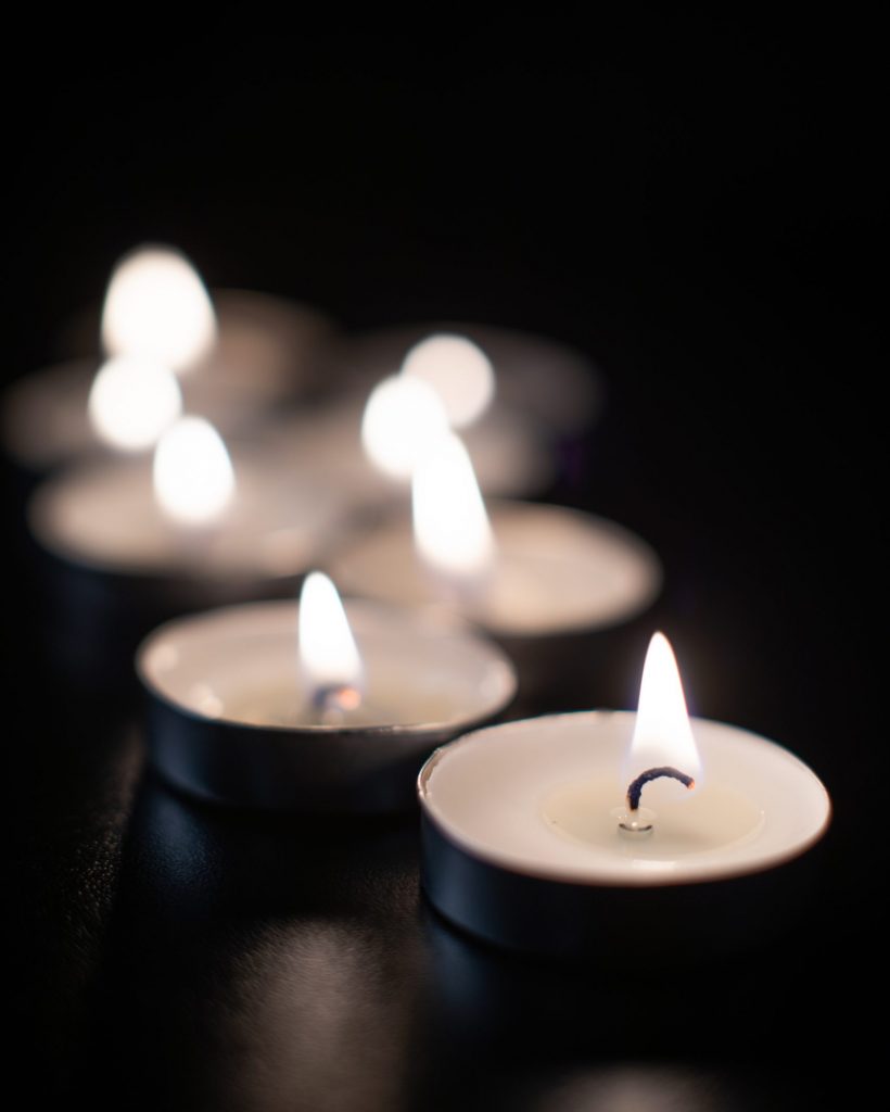 front-view-burning-candles-pitch-black-surface